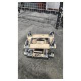 FOUR SMALL CARPETED MOVING DOLLIES