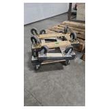 FOUR SMALL CARPETED MOVING DOLLIES