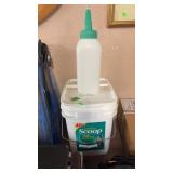 BUCKET OF CALF FEED BOTTLES
