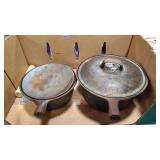 TWO CAST IRON POTS WITH LIDS