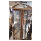 CURVED GLASS ANTQ LIGHTED CURIO W/  CARVED ACCENTS