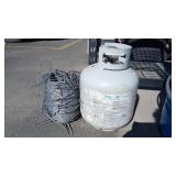 25 LB PROPANE TANK AND ROLL OF METAL WIRE