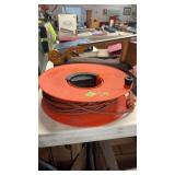 ORANGE EXTENSION CORD ON CORD REEL