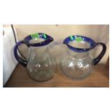 2 BLUE RIMMED PITCHERS, 1 IS ETCHED