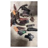 ASSORTED LEATHER HOLSTERS AND AMMO BELTS
