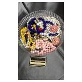 Costume jewelry and beads in plastic footed bowl