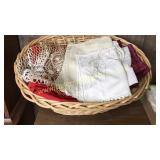 Large basket of linens- tablecloths, placemats,