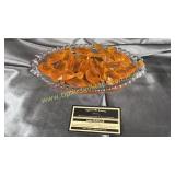 Group of plastic orange prisms on candlewick tray