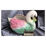 Old pottery swan planter has crack