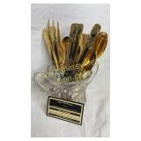 Gold finish flatware in spooner