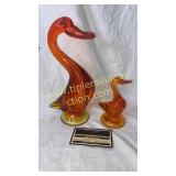 Orange art glass ducks