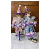 Pair of tricycle porcelain clowns