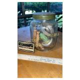 Vintage kitchen jar of cutters and clothes pins