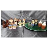 7 vintage salt and pepper shakers on green