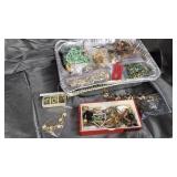 Tin of costume jewelry