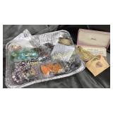 Tin of costume jewelry and vintage
