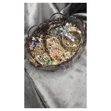 Bowl full of costume jewelry assortment
