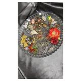 Glass platter of mostly vintage brooches