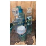 Group of old bottles and jars- lid on labeled jar