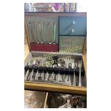 Mismatched vintage silverware in box