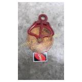 Red iron and wood pulley