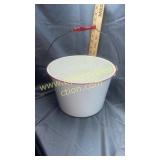 Res and white graniteware bucket