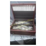 Silver chest with some flatware