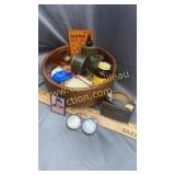 Wooden bowl full of old advertising and gun