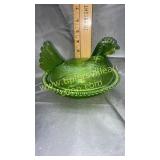 Green hen on the nest