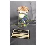 Mustard piggy bank with marbles