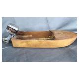 Old wooden toy boat with metal motor