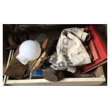 Wooden drawer with seed sack, books, saw, tools