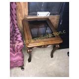 carved end table with glass top