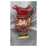 Hand painted cranberry pitcher has crack near