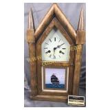 Clock with ship cabinet has pendulum and key