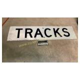 Metal tracks sign