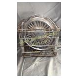 3 Chevy hubcaps in metal dairy crate