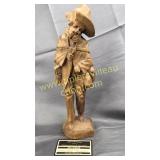 Barefoot man carved wooden statue