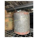 Galvanized and red fuel can