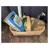 Basket of bottles and tin