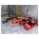 Group of NASCAR die cast cars and banks most have