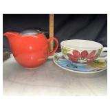 Red teapot with cup and saucer
