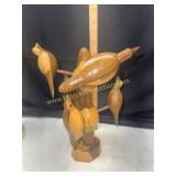 Hand carved folk art wooden birds in tree