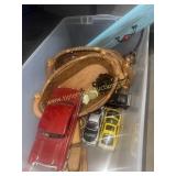 Model cars, oiler, baskets in tote