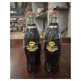 2 Coca-Cola bottles commemorating the 100th egg