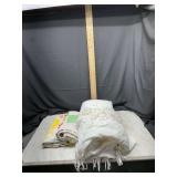 Lot of Folded Textiles Including White Fringe Throw and Patterned Fabric
