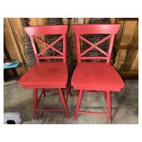 Pair of heavy red swivel bar stools