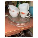 Fire king fleurette and red rose cups on clear fire king glass trivet