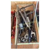 Wooden box with large wrenches, sockets and