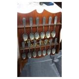 Collection of pewter? Spoons and rack